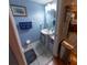 Cozy blue bathroom featuring a pedestal sink and decorative art at 13651 Forest Lake Dr, Largo, FL 33771