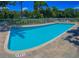 Inviting community pool with lounge chairs and a fenced perimeter for relaxation at 13651 Forest Lake Dr, Largo, FL 33771