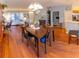 Open-concept dining area with hardwood floors, chandelier, and access to the kitchen and living room at 13651 Forest Lake Dr, Largo, FL 33771