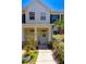 Townhome entrance featuring decorative wreath and stone pillar accents at 13651 Forest Lake Dr, Largo, FL 33771