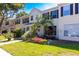 Charming townhome with black shutters and lush landscaping at 13651 Forest Lake Dr, Largo, FL 33771