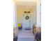 Inviting front porch with stone accents, a decorative wreath, and a bench at 13651 Forest Lake Dr, Largo, FL 33771