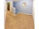 Upstairs hallway with neutral carpet leading to various rooms at 13651 Forest Lake Dr, Largo, FL 33771