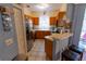Updated kitchen features stainless steel appliances, tile flooring, and breakfast bar at 13651 Forest Lake Dr, Largo, FL 33771