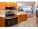 Modern kitchen showcases stainless steel appliances and open layout to living area at 13651 Forest Lake Dr, Largo, FL 33771