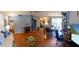 Open-concept living room with hardwood floors, cozy decor and multiple seating areas at 13651 Forest Lake Dr, Largo, FL 33771