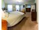 Bright main bedroom features two windows, soft carpet, and modern furnishings at 13651 Forest Lake Dr, Largo, FL 33771