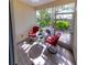 Enclosed screened patio with two chairs, small table and pleasant natural lighting at 13651 Forest Lake Dr, Largo, FL 33771