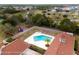 Aerial view of community pool with lounge chairs, playground, and palm tree at 14178 Pullman Dr, Spring Hill, FL 34609