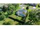 Aerial shot of a home, landscaped yard, pool, and privacy hedge at 14178 Pullman Dr, Spring Hill, FL 34609