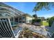 Enjoy outdoor relaxation near the pool, with a grill and outdoor seating in this serene backyard setting at 14178 Pullman Dr, Spring Hill, FL 34609