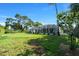 Expansive backyard with lush lawn, screened pool, and privacy hedging at 14178 Pullman Dr, Spring Hill, FL 34609