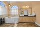 This primary bathroom features tile floors, a soaking tub and large window at 14178 Pullman Dr, Spring Hill, FL 34609