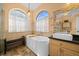 This bathroom features a tiled walk in shower and soaking tub with a view at 14178 Pullman Dr, Spring Hill, FL 34609
