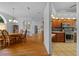 Open concept dining room featuring wood floors, an elegant chandelier, and decorative wainscotting at 14178 Pullman Dr, Spring Hill, FL 34609