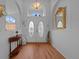 Welcoming foyer features hardwood floors, arched doorways, natural light, and decorative accents at 14178 Pullman Dr, Spring Hill, FL 34609