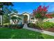 Beautiful front yard with green lawn, flowering tree, and attractive landscaping leading to the home's entryway at 14178 Pullman Dr, Spring Hill, FL 34609