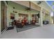The covered lanai offers a ceiling fan, comfortable seating, and stylish decor, perfect for outdoor living at 14178 Pullman Dr, Spring Hill, FL 34609