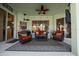 The outdoor living space showcases ample seating, sliding glass doors, and a ceiling fan for comfort at 14178 Pullman Dr, Spring Hill, FL 34609