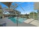 A screened-in pool provides a perfect outdoor escape, complemented by a spacious patio and well-manicured landscaping at 14178 Pullman Dr, Spring Hill, FL 34609