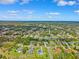 Extensive aerial view of a residential neighborhood showcasing homes with mature trees and landscaping on a sunny day at 1478 Brigadier Dr, Spring Hill, FL 34608