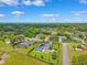 Expansive aerial view of a neighborhood showcasing lush greenery and a home with a pool and solar panels at 1478 Brigadier Dr, Spring Hill, FL 34608