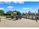 Outdoor kitchen with bar, fireplace, and seating, perfect for entertaining in this landscaped backyard at 1478 Brigadier Dr, Spring Hill, FL 34608