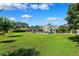 Backyard features a screened pool, patio, and outdoor kitchen, perfect for entertaining in a serene setting at 1478 Brigadier Dr, Spring Hill, FL 34608