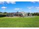 A lush backyard with a screened pool, patio, and an outdoor cooking area enhances the homes appeal at 1478 Brigadier Dr, Spring Hill, FL 34608