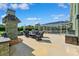 Outdoor living space with a pool, fireplace, outdoor kitchen, and comfortable seating at 1478 Brigadier Dr, Spring Hill, FL 34608