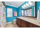 A colorful bathroom with a vanity, mirror, and window at 1478 Brigadier Dr, Spring Hill, FL 34608