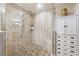 A tiled walk-in shower features pebble flooring and a frameless glass enclosure at 1478 Brigadier Dr, Spring Hill, FL 34608