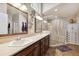 Bright bathroom with double vanity, glass shower, and custom cabinet for ample storage at 1478 Brigadier Dr, Spring Hill, FL 34608