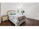 Bright bedroom features dark wood floors, ceiling fan, and natural light from the windows at 1478 Brigadier Dr, Spring Hill, FL 34608