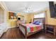 A bright bedroom with a colorful quilt, ceiling fan, and dresser at 1478 Brigadier Dr, Spring Hill, FL 34608