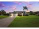 Charming home with large front yard, mature palm trees, and a two car garage at 1478 Brigadier Dr, Spring Hill, FL 34608