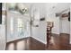 Inviting foyer with decorative glass front door and hardwood floors leading to the dining room at 1478 Brigadier Dr, Spring Hill, FL 34608