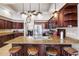 Open kitchen with dark wood cabinets, a large island, and modern appliances at 1478 Brigadier Dr, Spring Hill, FL 34608
