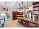 Open kitchen featuring a large island with seating, stainless appliances, and pendant lighting at 1478 Brigadier Dr, Spring Hill, FL 34608