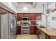 A modern kitchen boasts stainless steel appliances, granite countertops and dark wood cabinetry at 1478 Brigadier Dr, Spring Hill, FL 34608