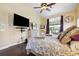 An expansive main bedroom shows a large bed with soft linens, and a ceiling fan at 1478 Brigadier Dr, Spring Hill, FL 34608
