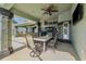 A covered outdoor patio with a dining table, chairs, and ceiling fans for comfortable outdoor living at 1478 Brigadier Dr, Spring Hill, FL 34608