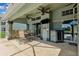 Covered patio featuring a dining table, ceiling fans, outdoor kitchen area, and views of the backyard at 1478 Brigadier Dr, Spring Hill, FL 34608