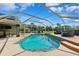 A backyard with an enclosed pool, outdoor kitchen, seating area, and landscaping at 1478 Brigadier Dr, Spring Hill, FL 34608