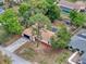 An aerial view of a well-maintained single-Gathering home with a long driveway and mature landscaping at 1652 Larkin Rd, Spring Hill, FL 34608