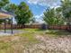 Large backyard features mature trees, privacy fence, and a shed for extra storage space at 1652 Larkin Rd, Spring Hill, FL 34608