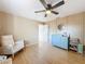 Bright bedroom features wood floors, a ceiling fan, and a charming blue changing table at 1652 Larkin Rd, Spring Hill, FL 34608