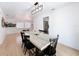 Well-lit dining room features a wood table, black chairs, and modern light fixture at 1652 Larkin Rd, Spring Hill, FL 34608