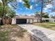 Inviting single-story house with a spacious driveway and tasteful landscaping at 1652 Larkin Rd, Spring Hill, FL 34608