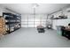 Spacious garage featuring epoxy flooring, ample storage shelves, and an automatic door opener at 1652 Larkin Rd, Spring Hill, FL 34608